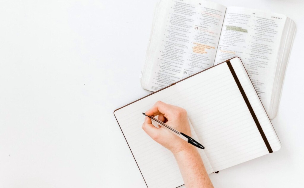 ノートに文字を書こうとしている人